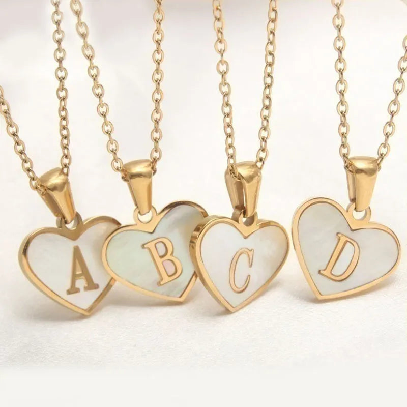 Gold plated heart-shaped white shell pendant personalised initial necklace on a stainless steel chain.