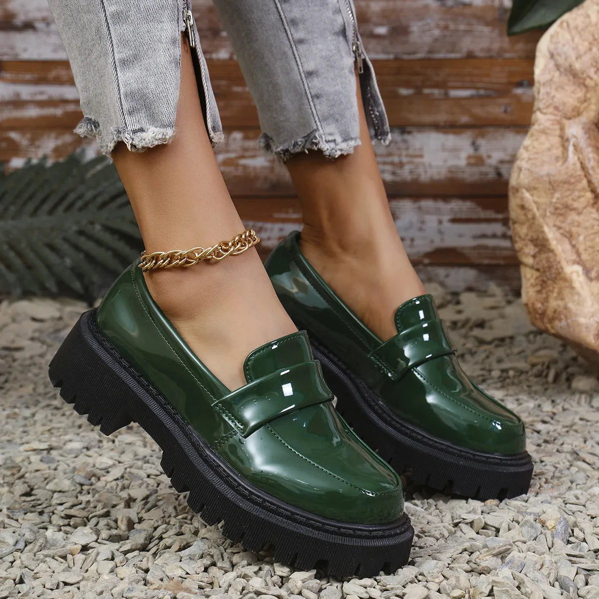 Plus size black slip-on loafers with a chunky platform heel and thick rubber sole.