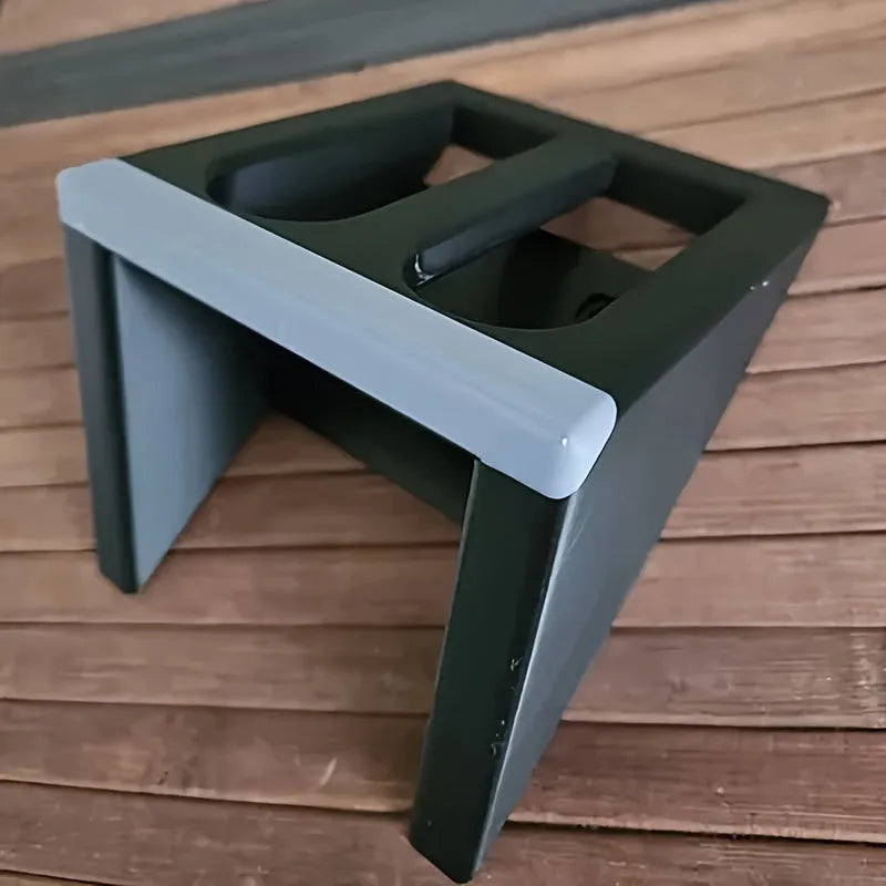 Black plastic punk-style pistol display stand for airsoft guns, measuring 10.85 by 7.6 cm.