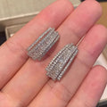 Geometric copper stud earrings with inlaid zircon stones in white gold colour finish.