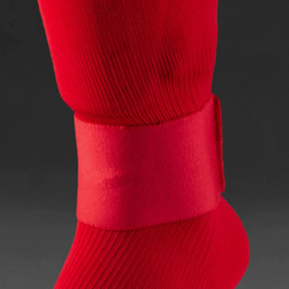Red rubber elastic strap for securing football shin guards, shown flat measuring 25cm long.