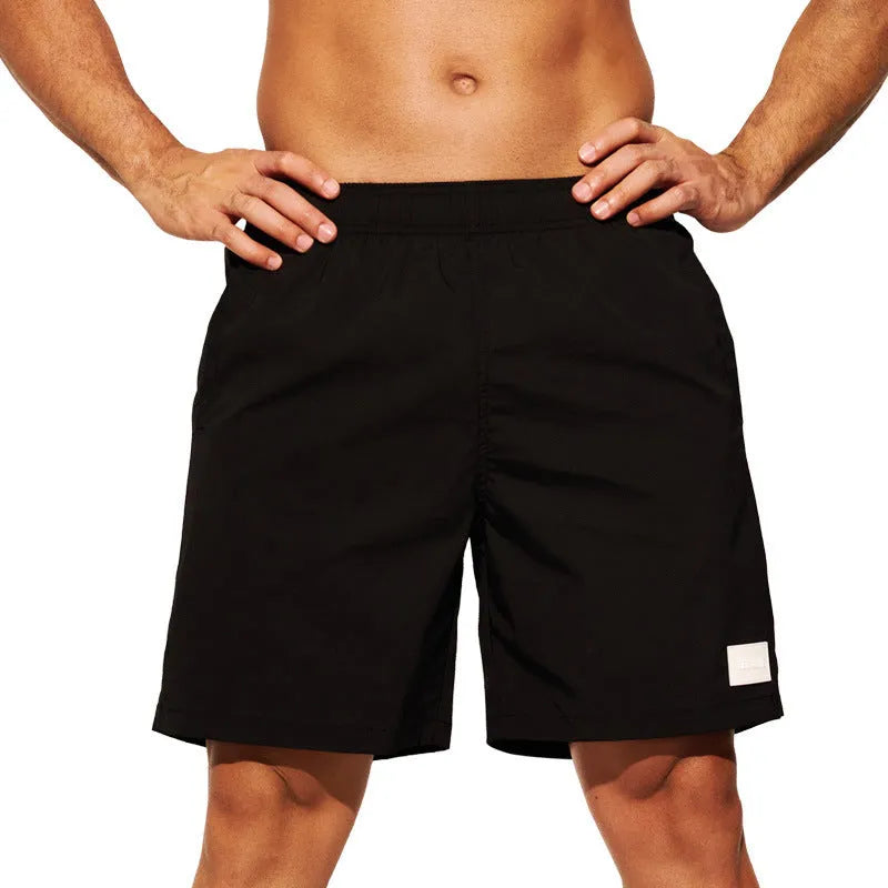Men's quick-drying nylon shorts in solid colours with straight leg opening for beach and sports