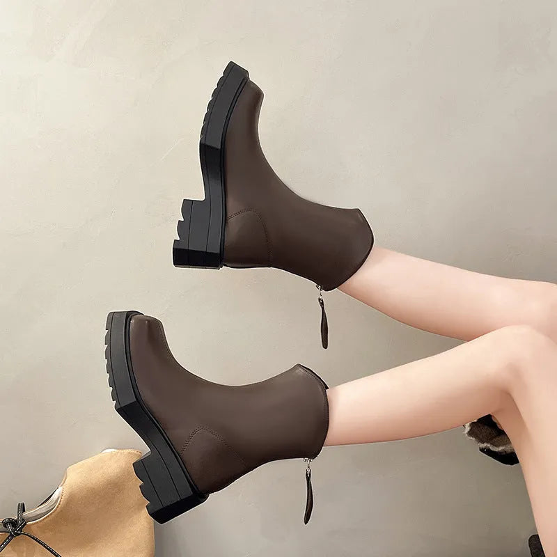 Black women's platform Martin boots with a square toe, high heel, and back zip.