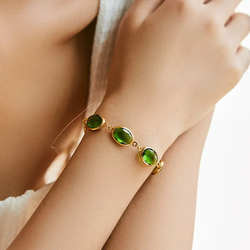 Geometric elliptical women's bracelet with blue glass inlay on an 18K copper band.