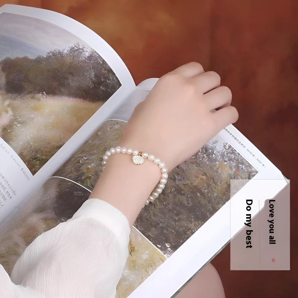 Women's freshwater pearl bracelet with fan-shaped design and alloy details.