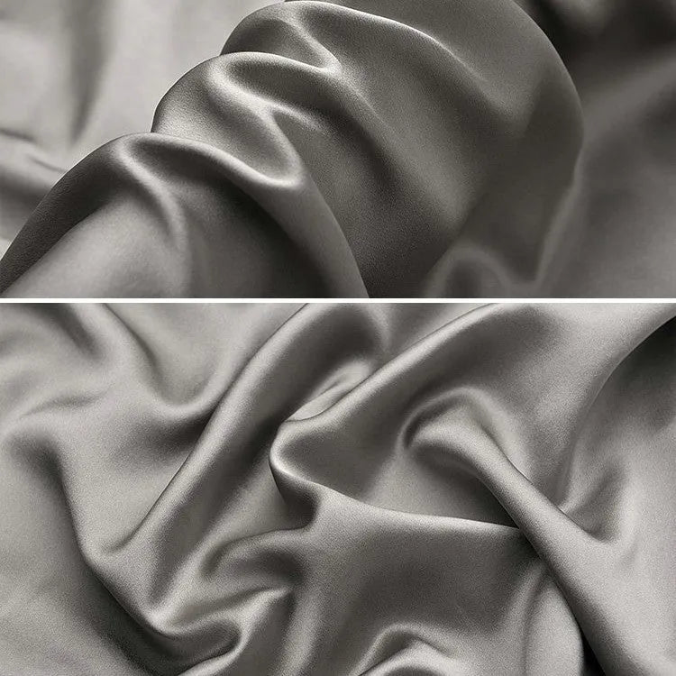 Dark gray envelope closure silk pillowcase on a bed