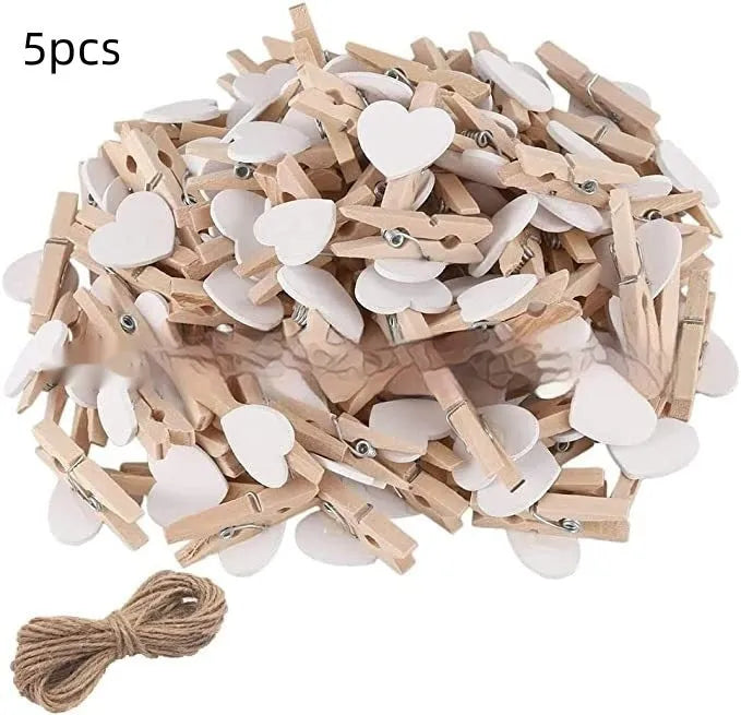 Five small solid wood heart-shaped clips in different colours showing handmade craft details