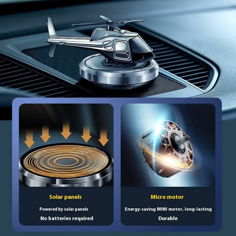 Silver metal helicopter car air freshener with rotating blades on dashboard