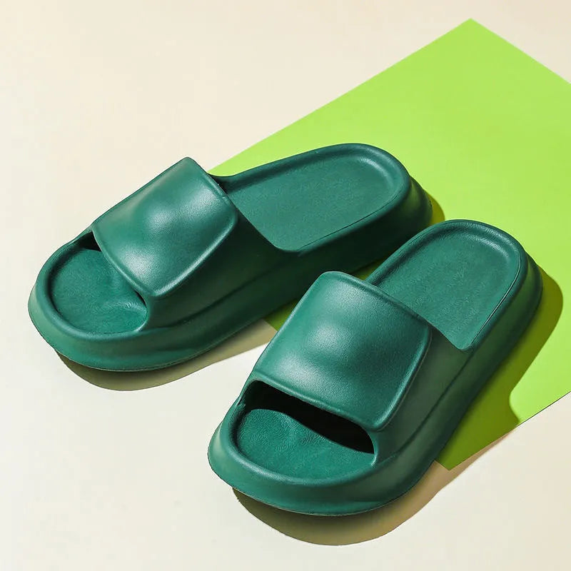 Thick-soled EVA flip-flop slippers in multiple colours on a bathroom floor, showing non-slip sole texture.