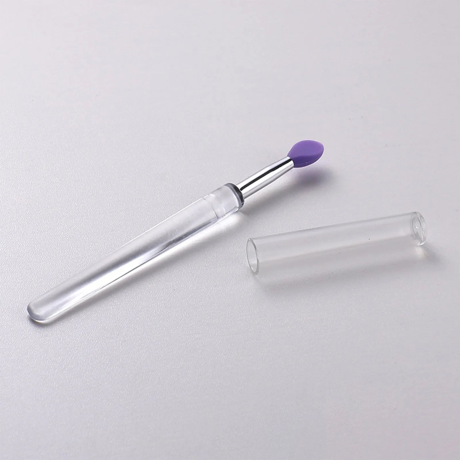 Silicone lip brush with protective cap for hygienic lip product application