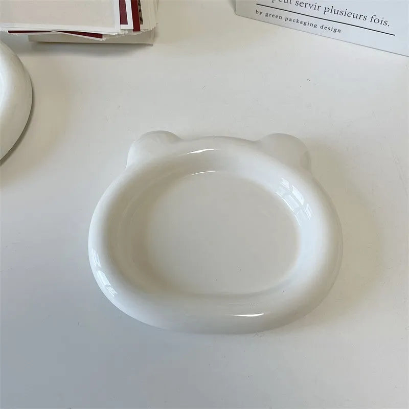 White ceramic chubby toot plate with doodle design, shown in bear and round styles.