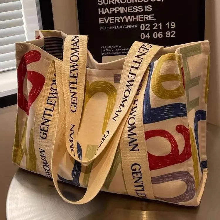 Canvas women's tote bag with printed letter or pattern designs and shoulder straps