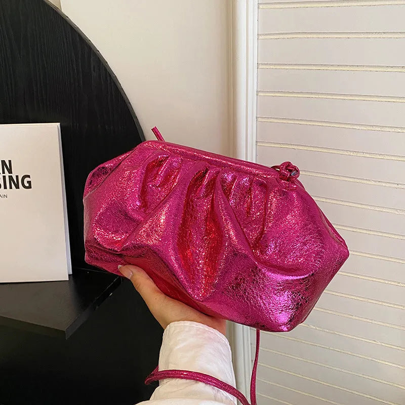 Simple hair clip fastening crossbody bag in shell shape, shown in rose red colour.