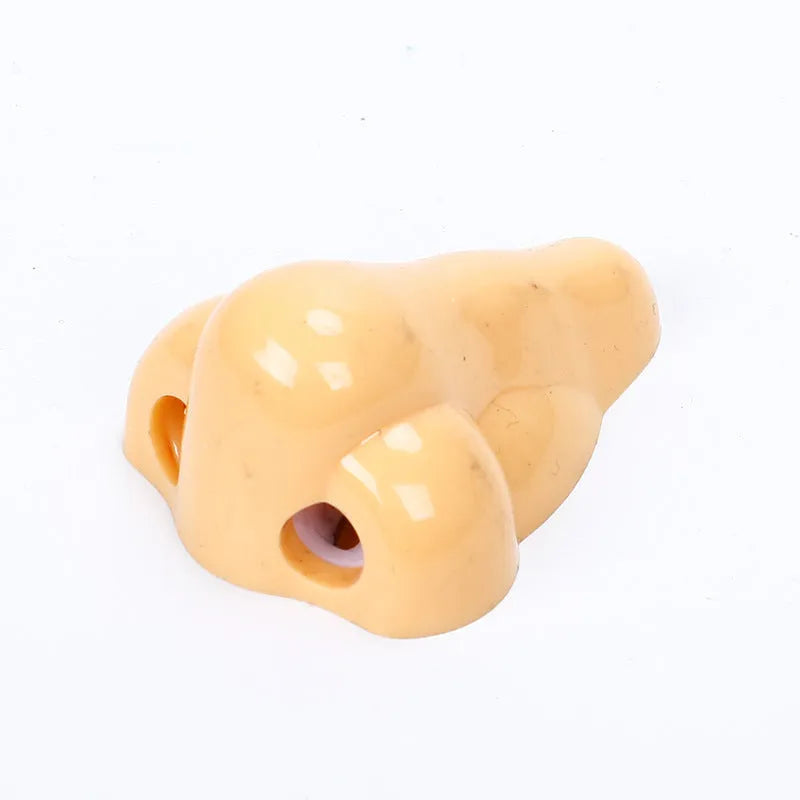 Flesh colour plastic pencil sharpener with geometry shape measuring 58x45x30 mm