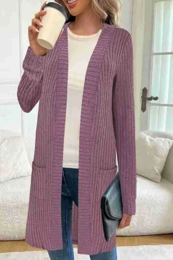 Long sleeve loose fit knitted cardigan jacket in black, shown with two front pockets.