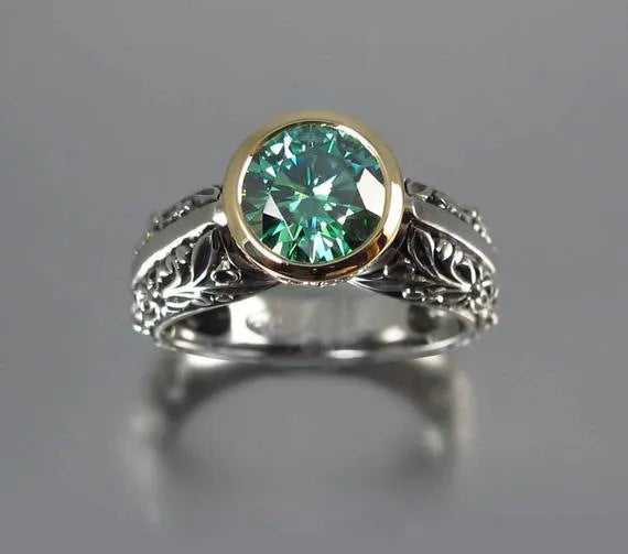 Gold and silver vintage flower-shaped ring with a central green gemstone, shown in a size selection.