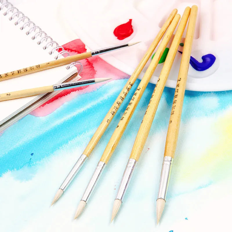 Six wooden-handled art brushes with pointed wool tips arranged together