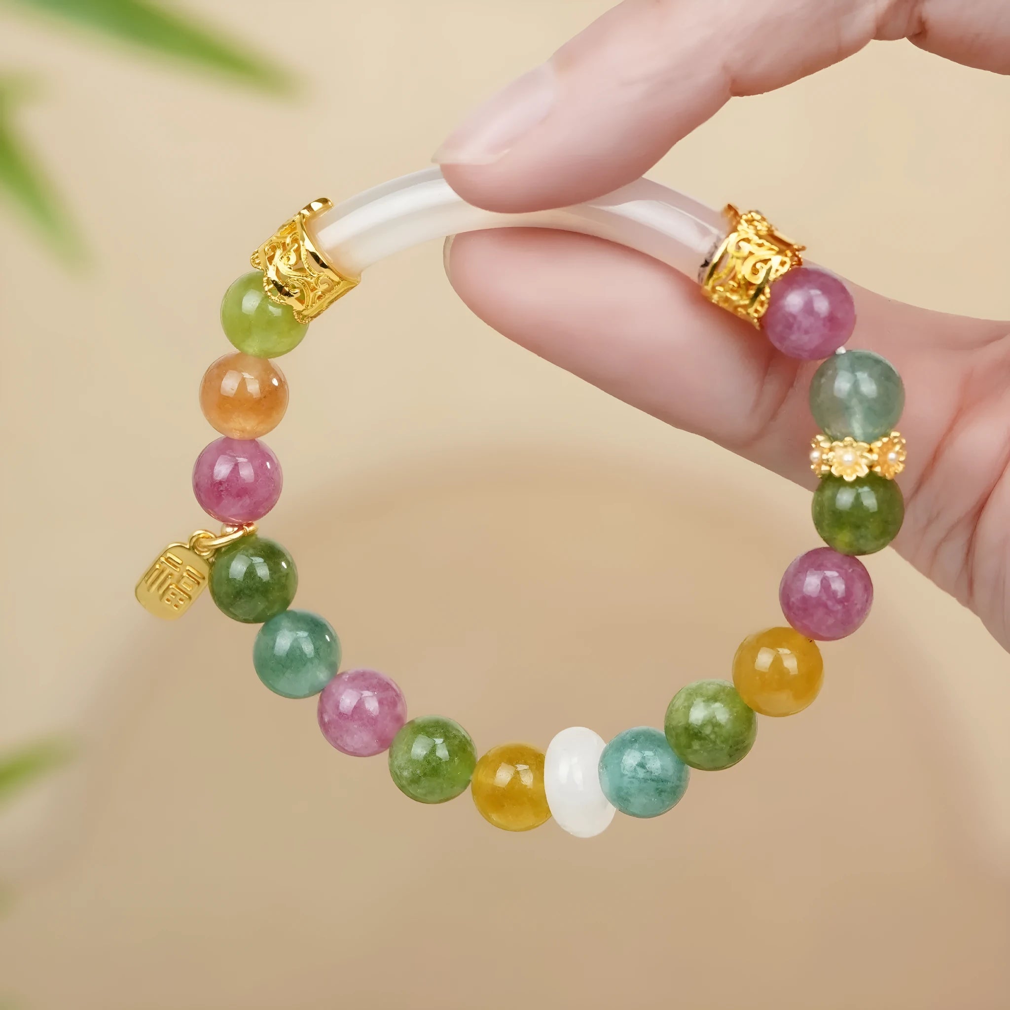 Rainbow-coloured women's half bracelet made from natural tourmaline with a pith centrepiece.