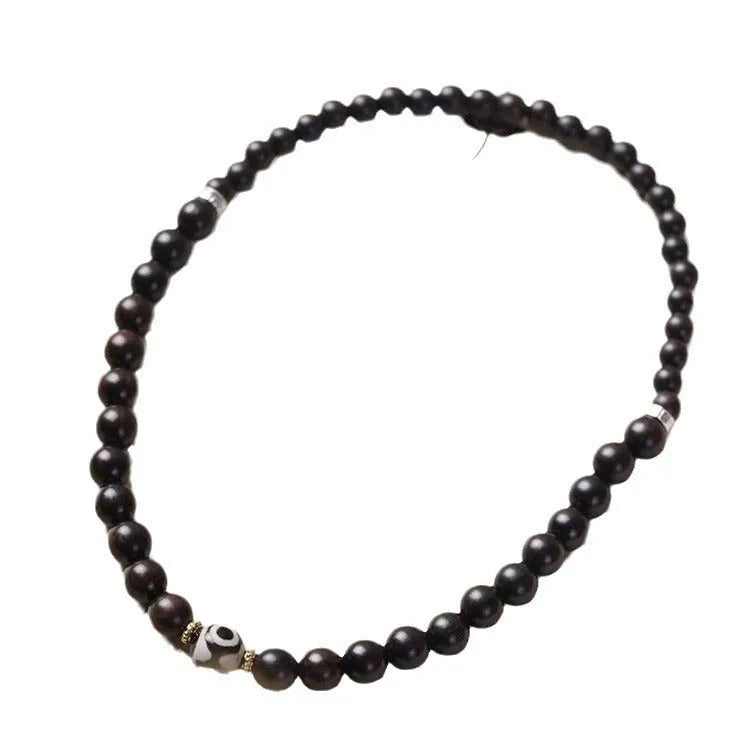 Ebony wood Tibetan bracelet with 8mm beads and two-circle pattern on wrist