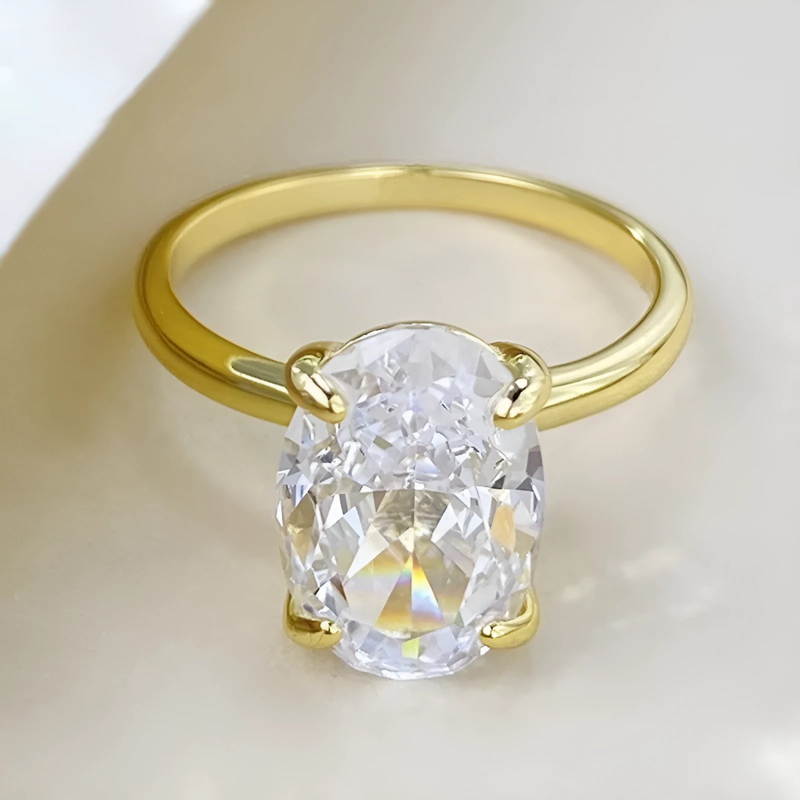 Oval 9 silver women's ring with four-claw setting holding a hand-cut gemstone.