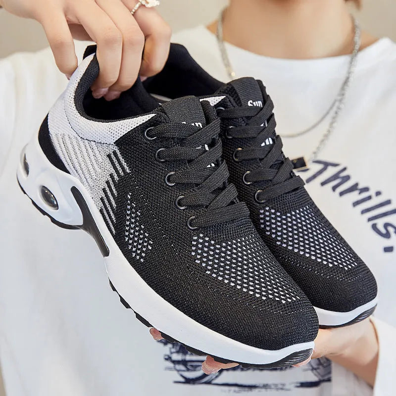 Women's pink Flyknit casual running shoes with mesh lining and flat PVC sole.