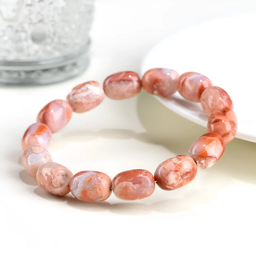 Natural cherry agate bracelet with barrel-shaped beads showing Ruyi geometric design