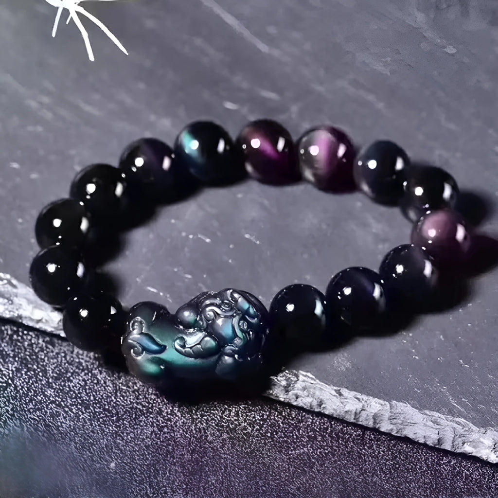 Natural ice colour eye obsidian crystal bracelet on a wrist, showing detail of the stone beads.
