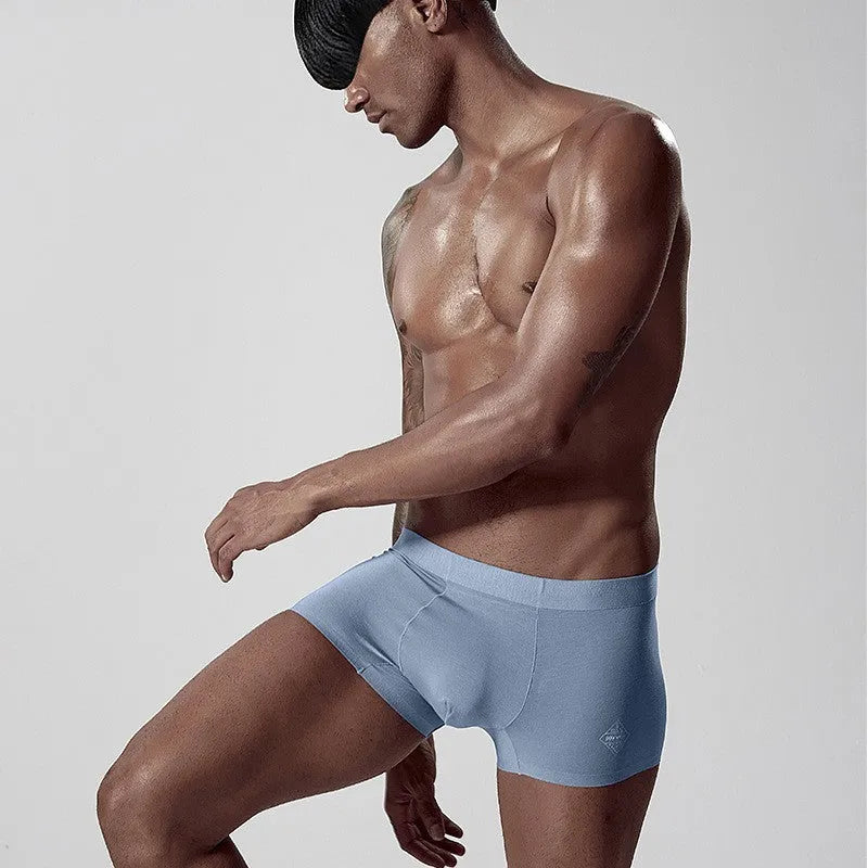 Men's seamless one-piece modal underwear in green, showing mid-waist fit and solid colour design.