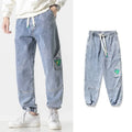 Men's loose-fit tapered cotton trousers in black colour showing mid-waist design and tapered leg cut
