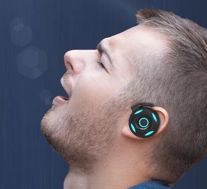 Black Bluetooth earphones with hanging ear design and USB charging cable