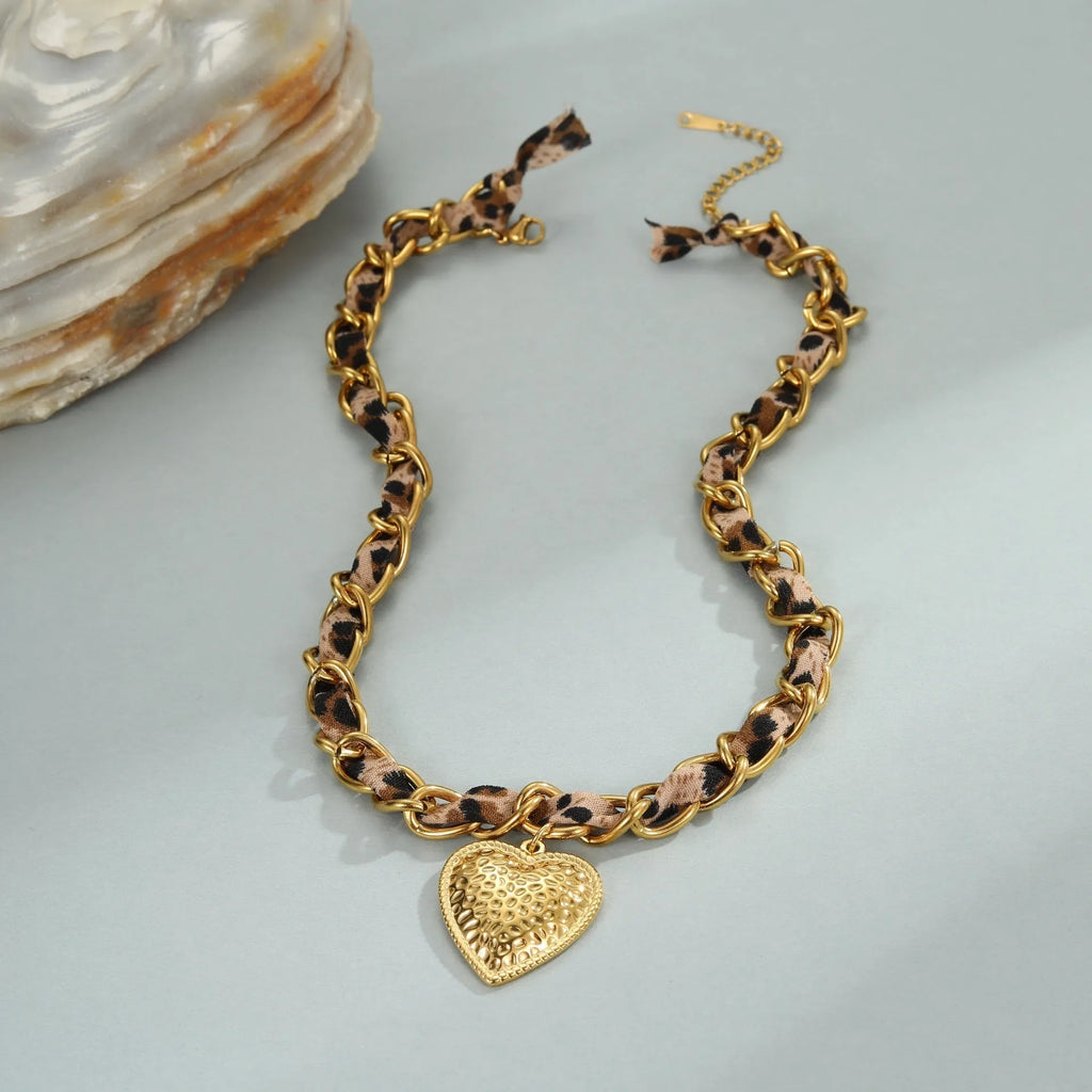 Gold-plated stainless steel necklace with leopard and love geometric pendant on an adjustable chain.