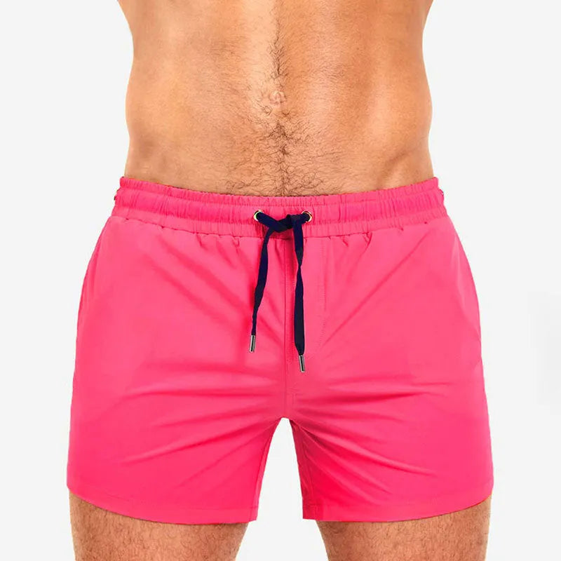 Men's solid colour polyester sports shorts with mesh lining, shown in Army Green, for swimming and fitness.