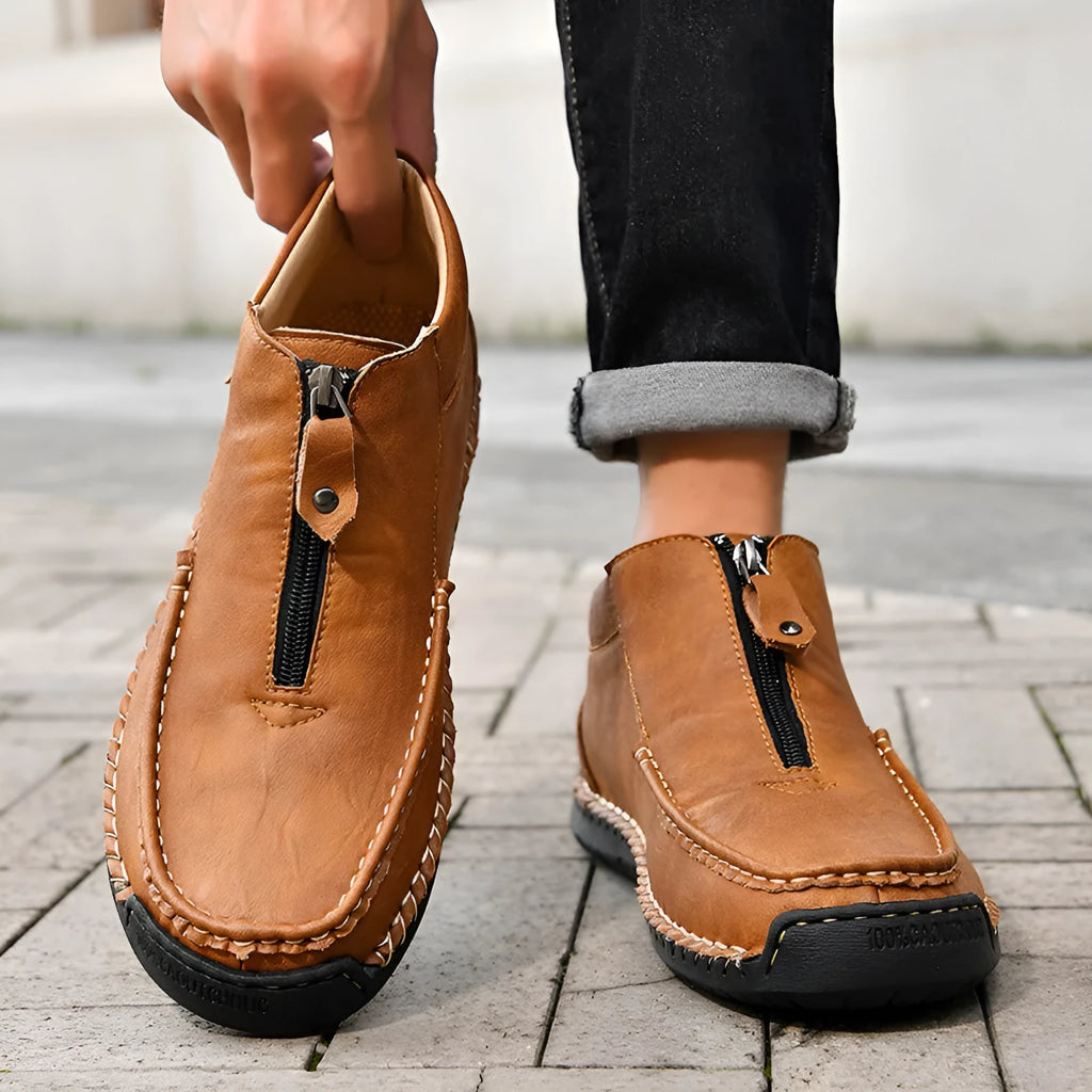 Men's slip-on leather loafers in black, brown, and grey colours showing round toe and rubber sole