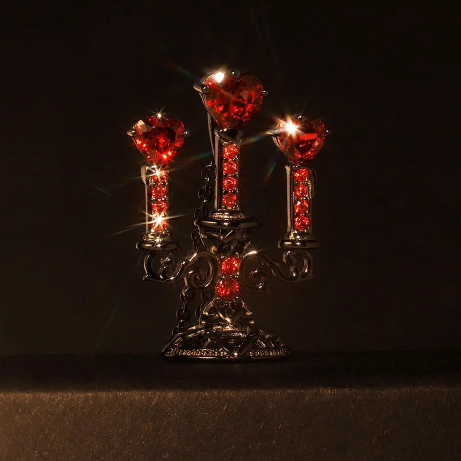 Close-up of a retro-style hollow candlestick pendant necklace with a cross chain, in a gothic design.
