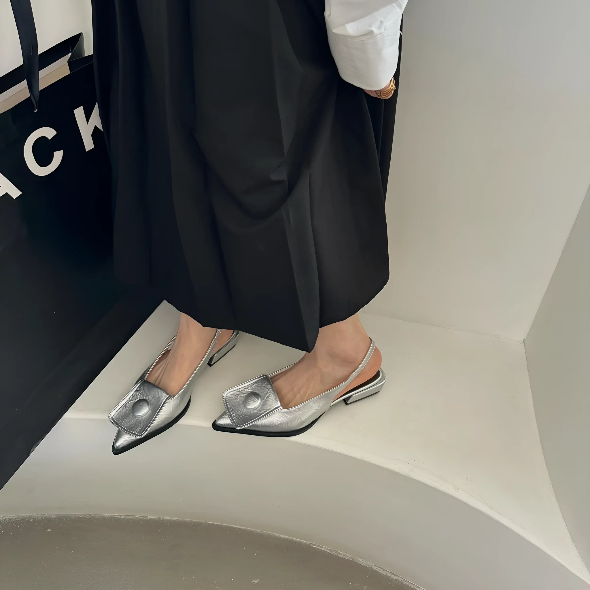 Women's pointed toe low heel sandals with back strap in apricot colour.