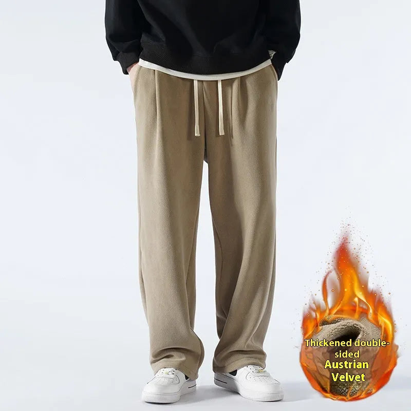 Men's thick apricot coloured fleece-lined loose fit casual sports trousers on a hanger.