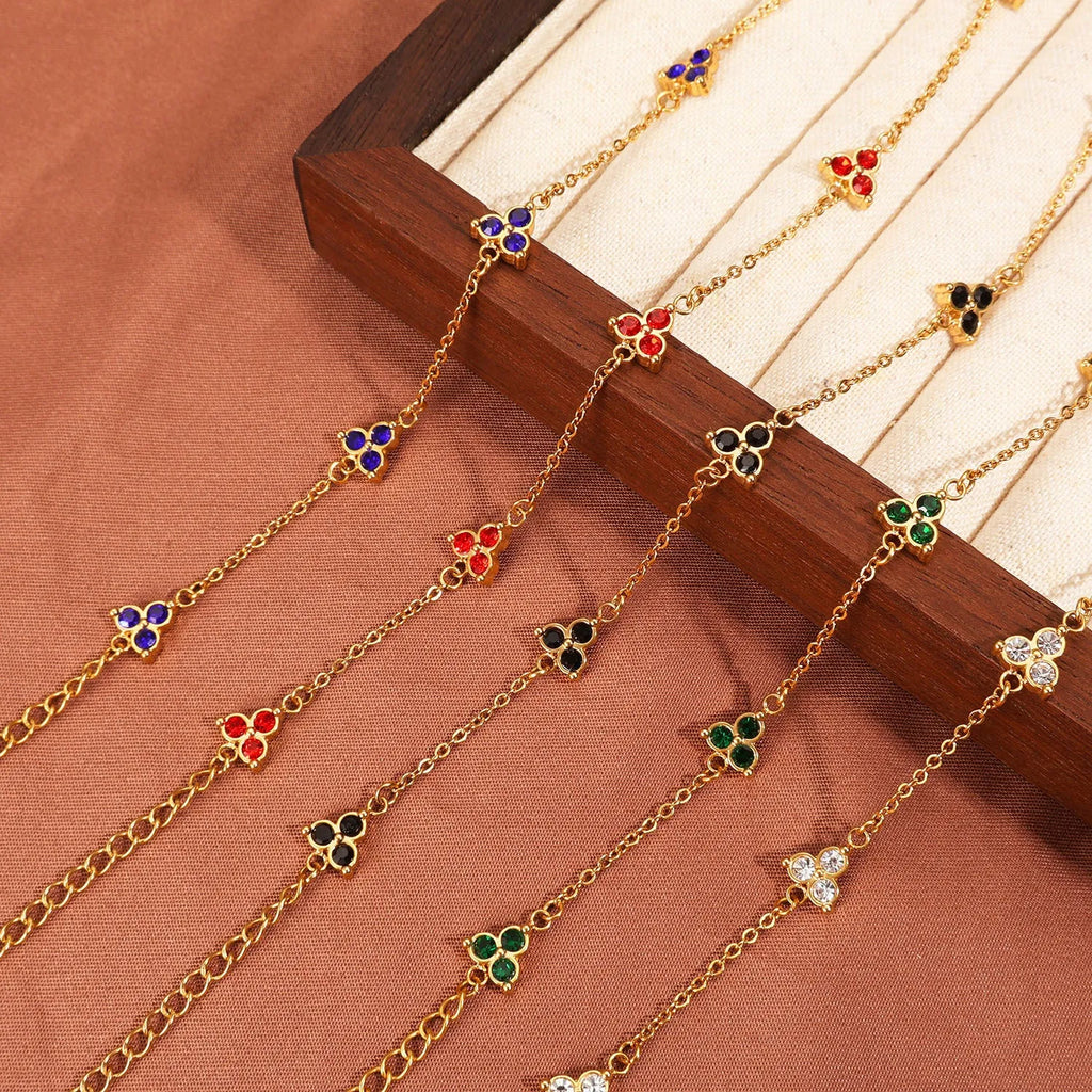 Women's stainless steel bracelet with three triangular charms set with coloured zircon stones.