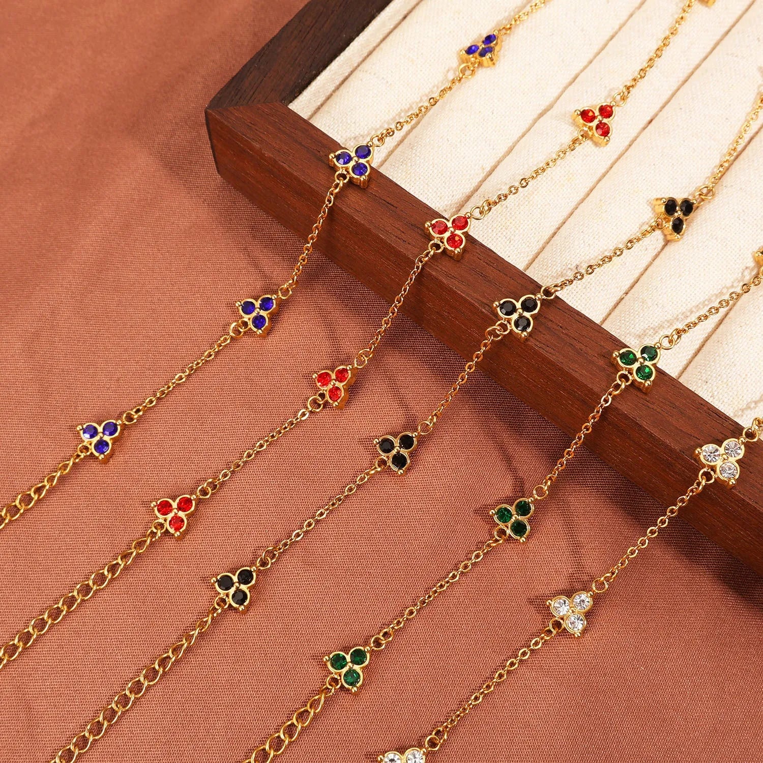 Women's stainless steel bracelet with three triangular charms set with coloured zircon stones.