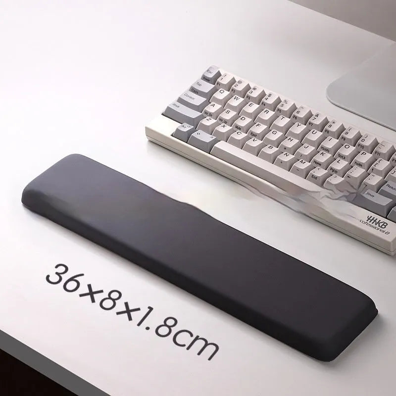 Square black silica gel wrist rest mouse pad with cloth surface on a desk.