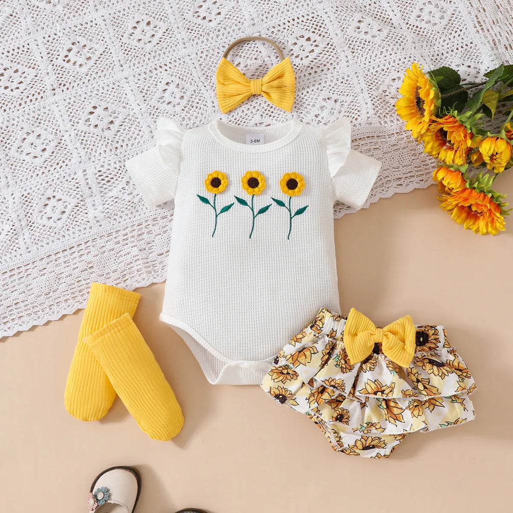 Baby girl yellow triangle ruffled shorts suit with white blouse and bow detail on baby model