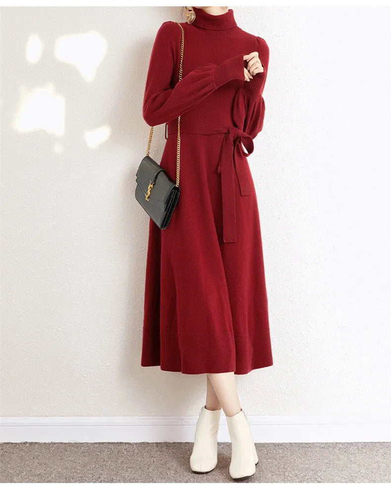 Women's knitted turtleneck dress with long sleeves, elastic waist, and a loose A-line skirt in a solid colour.