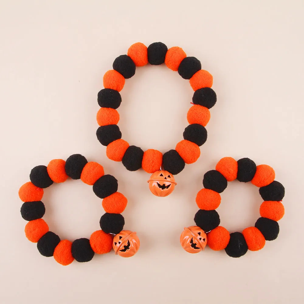 Orange Halloween cat collar with black pumpkin face design and a black adjustable buckle.