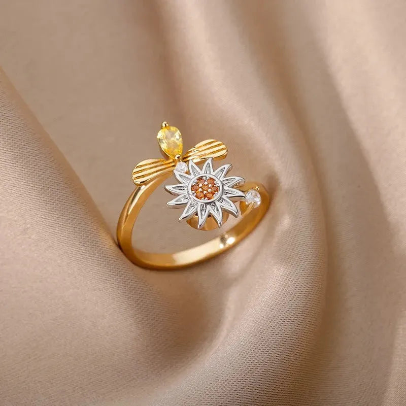 Adjustable copper ring with rotatable element in gold or platinum finish, simple geometric design