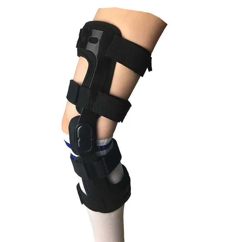Black adjustable anterior ligament knee support with straps, shown on a leg.