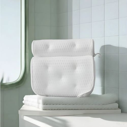 White bathtub pillow with 4D mesh fabric and suction cups on a flat surface.