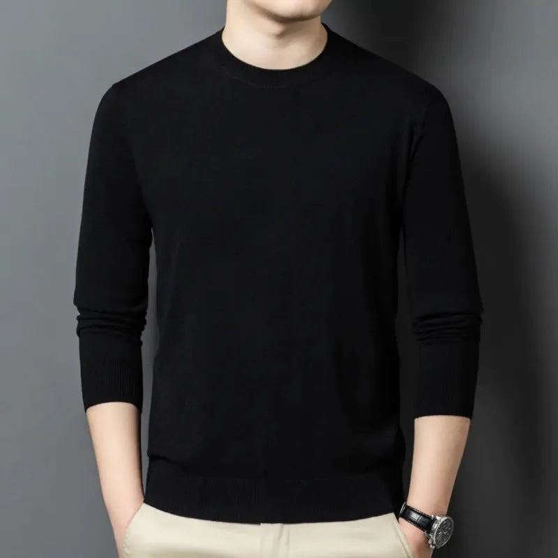 Man wearing a round neck grey wool blend sweater with long sleeves.