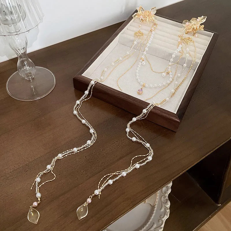 Gold women's hairpin with a pearl diamond flower and a long tassel.