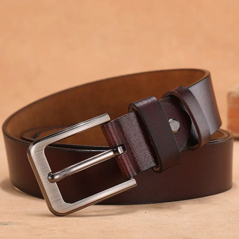 Black casual jeans belt with a square silver alloy pin buckle on a length guide.