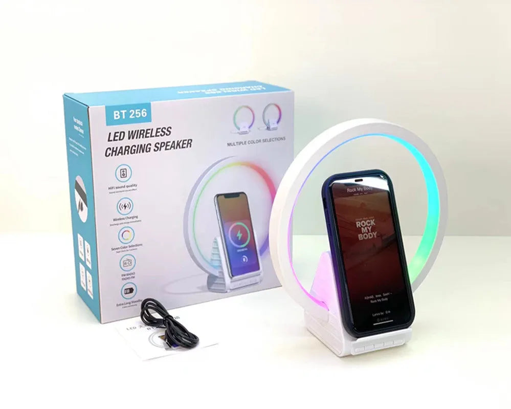 White Bluetooth speaker with wireless charging surface and ambient lighting