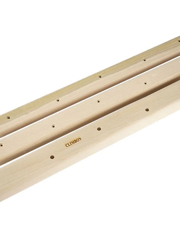 Three wooden hangboards for grip strength training in different lengths mounted for exercise